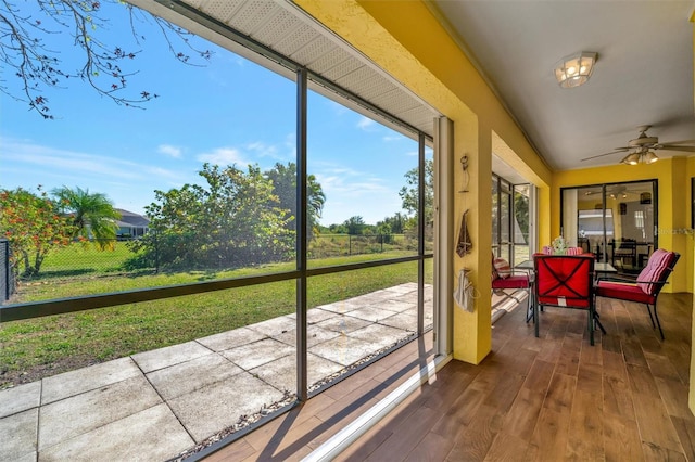 sunroom / solarium featuring ceiling fan