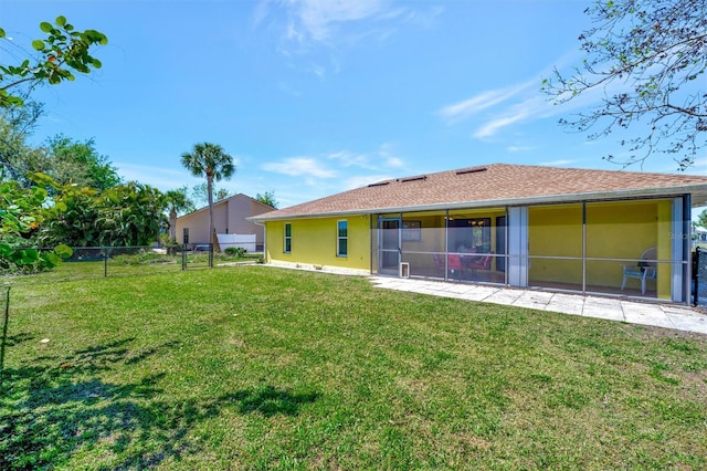 back of property featuring a lawn, fence, a sunroom, and stucco siding