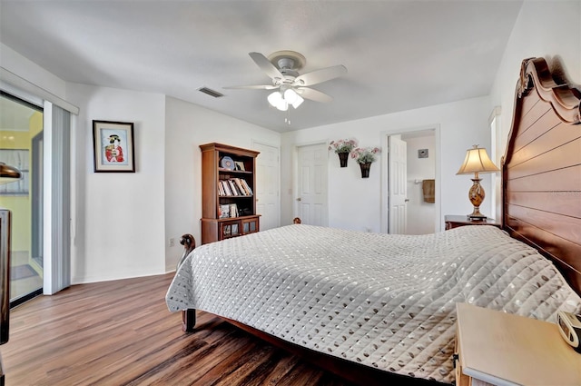 bedroom featuring visible vents, access to exterior, wood finished floors, baseboards, and ceiling fan