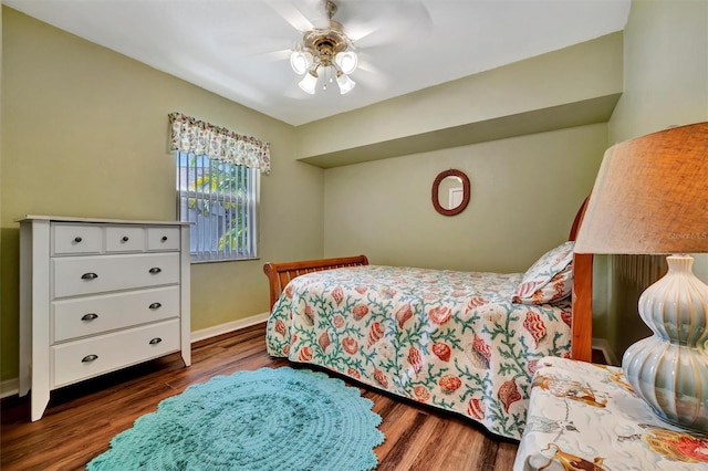 bedroom featuring baseboards, dark wood-type flooring, and ceiling fan