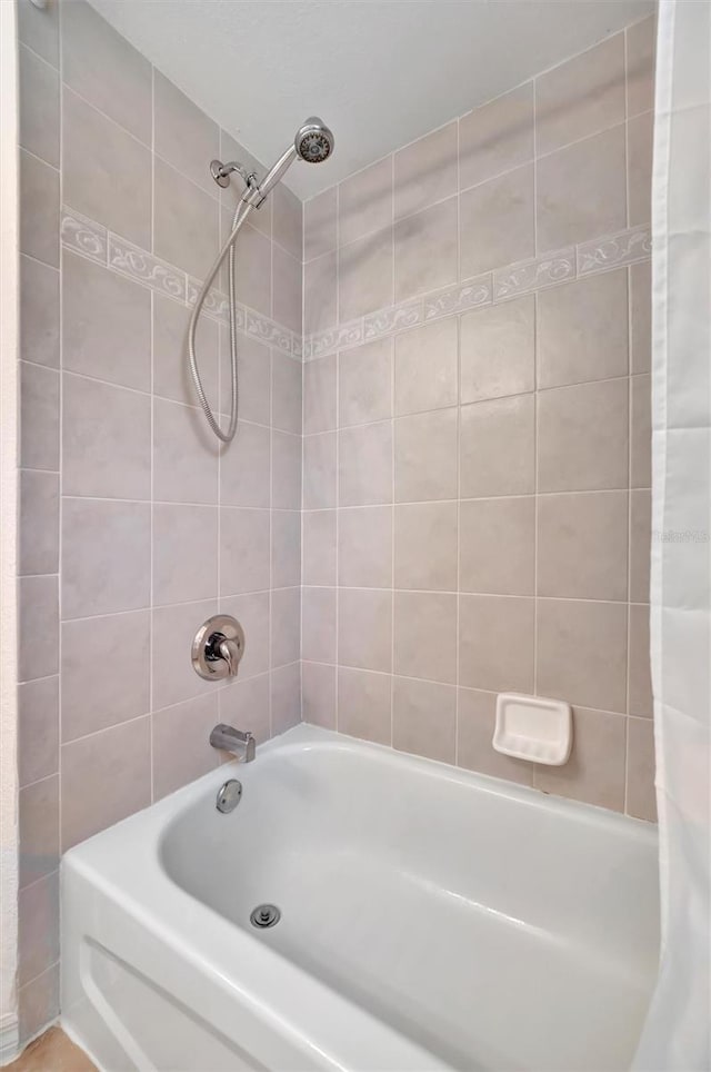 bathroom featuring shower / bathtub combination with curtain