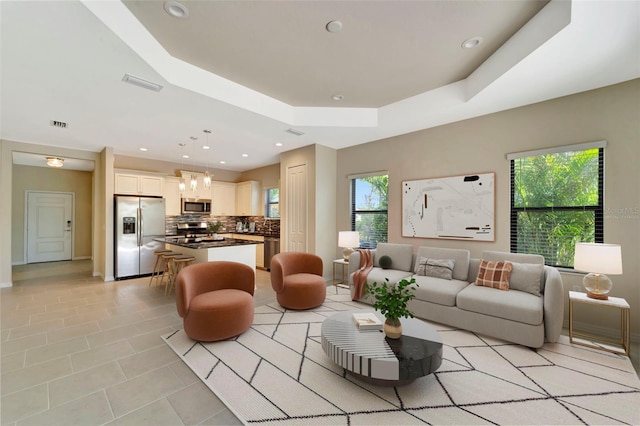 324 Casalino Dr, Nokomis, FL 34275 - living room featuring visible vents, recessed lighting, baseboards, light tile patterned flooring, and a raised ceiling