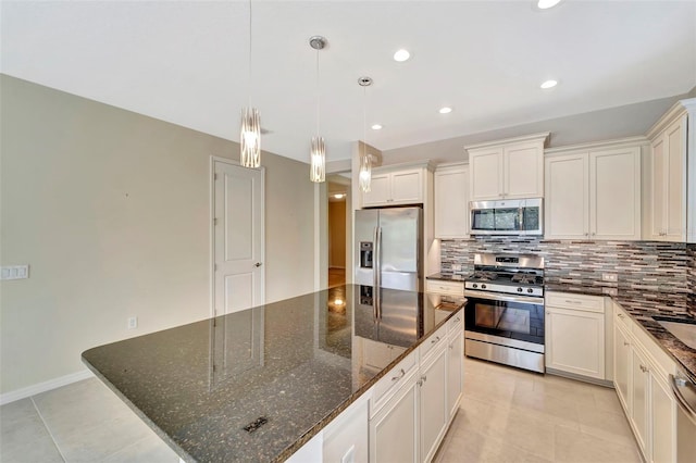 324 Casalino Dr, Nokomis, FL 34275 - kitchen with decorative backsplash, appliances with stainless steel finishes, white cabinets, and a center island