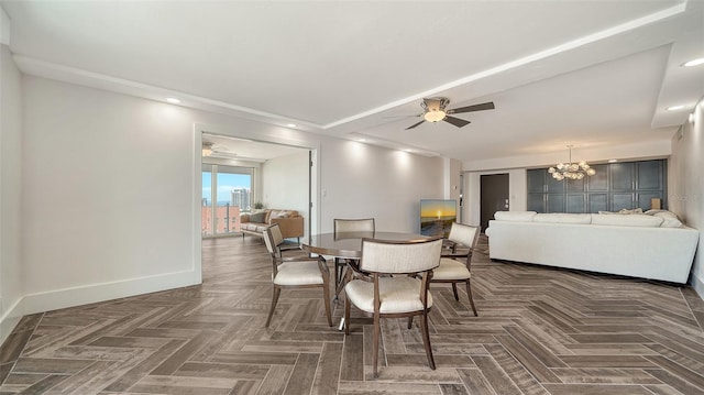 dining space featuring baseboards and ceiling fan with notable chandelier