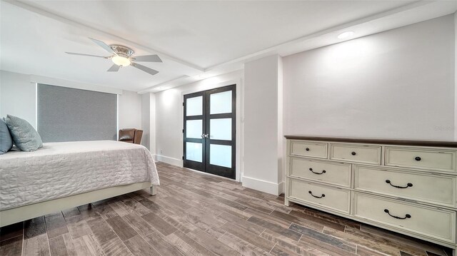 bedroom featuring french doors, a ceiling fan, baseboards, and wood finished floors