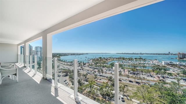 balcony featuring a water view and a city view