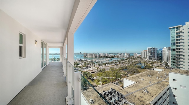 balcony featuring a view of city and a water view