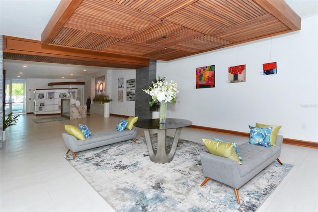 living room featuring baseboards and wood ceiling