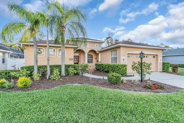 11835 Hollyhock Dr, Lakewood Ranch, FL 34202 - view of front facade with stucco siding, driveway, a front yard, and a garage