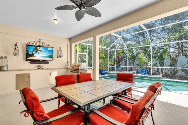 view of patio featuring glass enclosure, outdoor dining space, area for grilling, an outdoor kitchen, and an outdoor pool