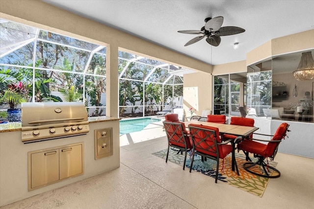 view of patio / terrace featuring a lanai, an outdoor kitchen, a grill, and ceiling fan