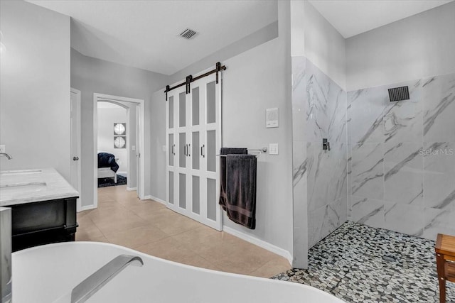 ensuite bathroom featuring a marble finish shower, visible vents, tile patterned floors, and a freestanding tub