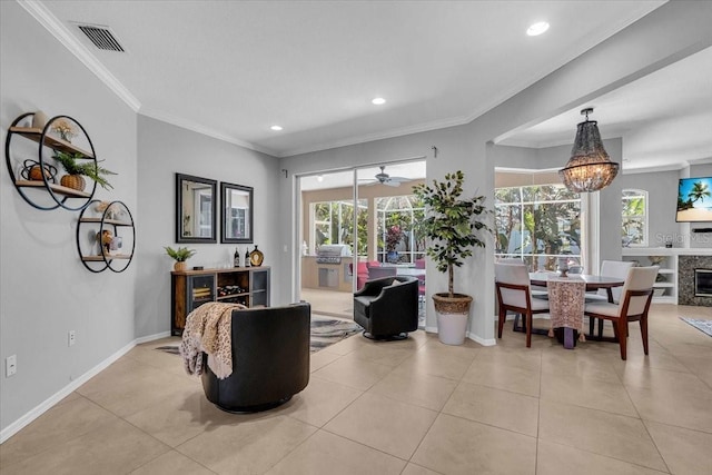 living area with tile patterned flooring, baseboards, visible vents, and ornamental molding