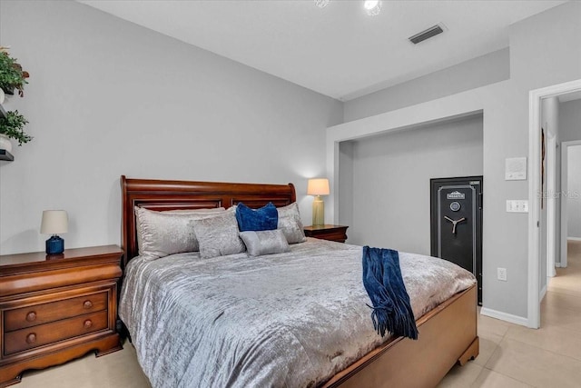 bedroom featuring light tile patterned flooring, baseboards, and visible vents