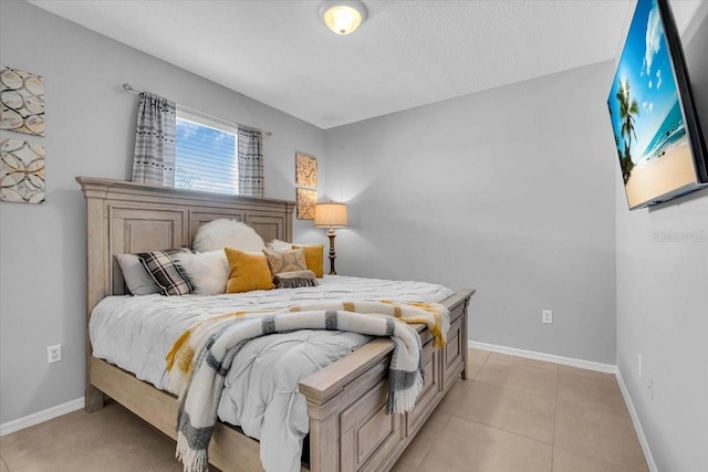 bedroom featuring baseboards and light tile patterned flooring