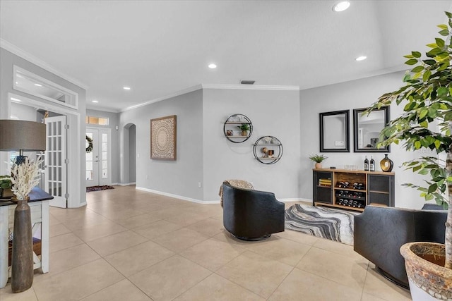 interior space with light tile patterned floors, visible vents, arched walkways, and crown molding