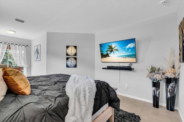 tiled bedroom featuring visible vents, baseboards, and a textured ceiling