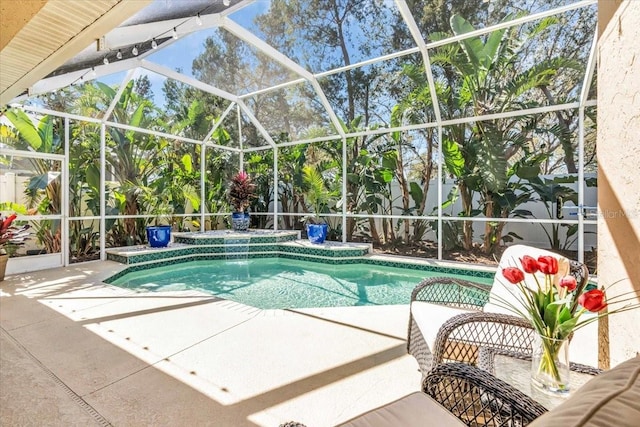 outdoor pool featuring a patio area and a lanai