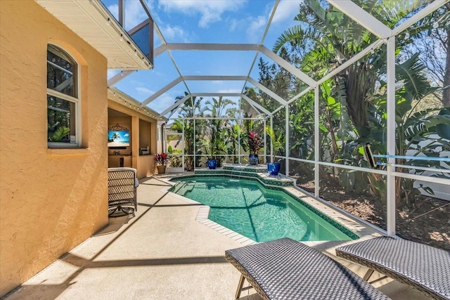 outdoor pool featuring a lanai and a patio area