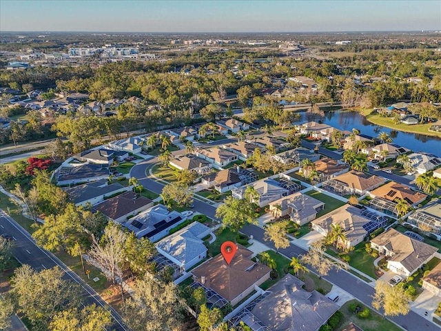 drone / aerial view featuring a residential view and a water view