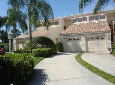 view of front facade with stucco siding and concrete driveway