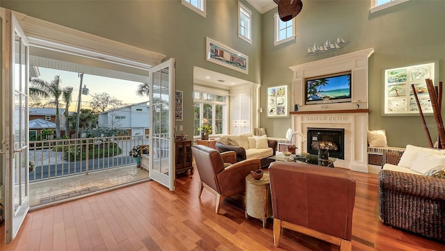 living room featuring a premium fireplace and wood finished floors