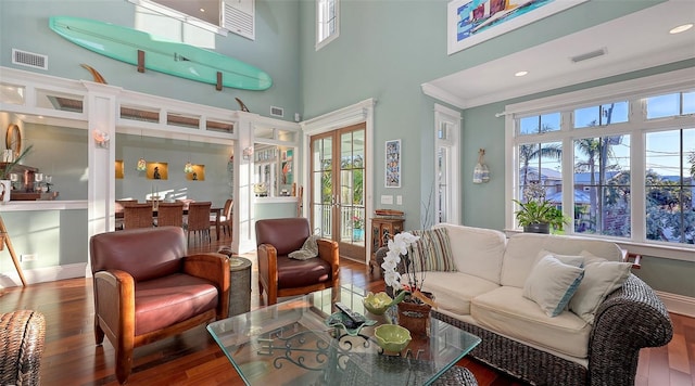 living room featuring visible vents, wood finished floors, and french doors