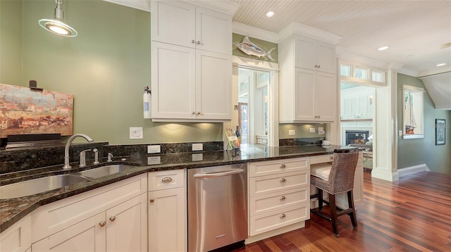 kitchen with dark wood-style flooring, white cabinets, dishwasher, and a sink