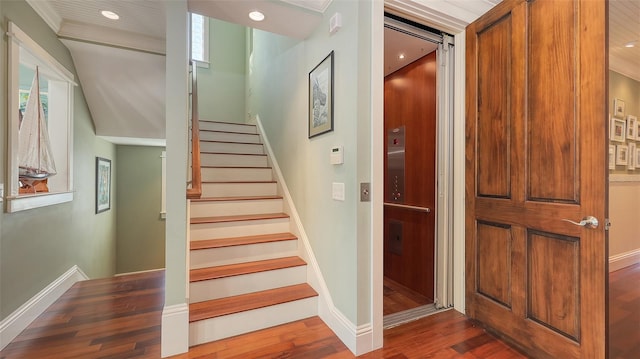 staircase with recessed lighting, baseboards, and wood finished floors