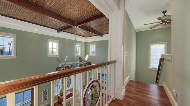 hallway with beamed ceiling, wood ceiling, ornamental molding, an upstairs landing, and wood finished floors