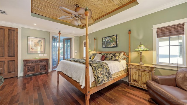 bedroom with ornamental molding, wood finished floors, a raised ceiling, a ceiling fan, and access to outside