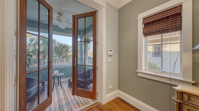 entryway with french doors, baseboards, light wood-type flooring, and a ceiling fan