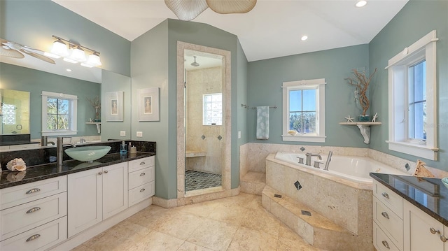 bathroom featuring a shower stall, a bath, a ceiling fan, and plenty of natural light