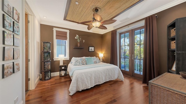 bedroom featuring baseboards, french doors, wood-type flooring, crown molding, and access to outside