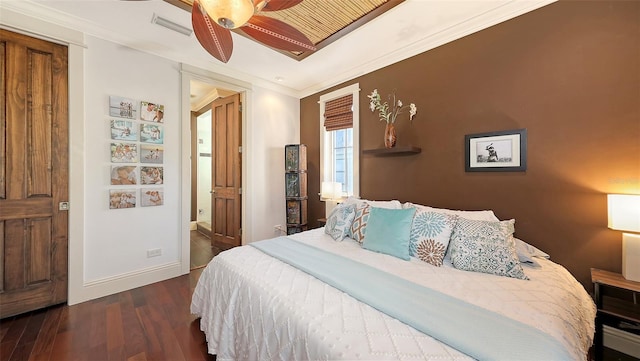 bedroom featuring visible vents, dark wood-style floors, connected bathroom, crown molding, and baseboards