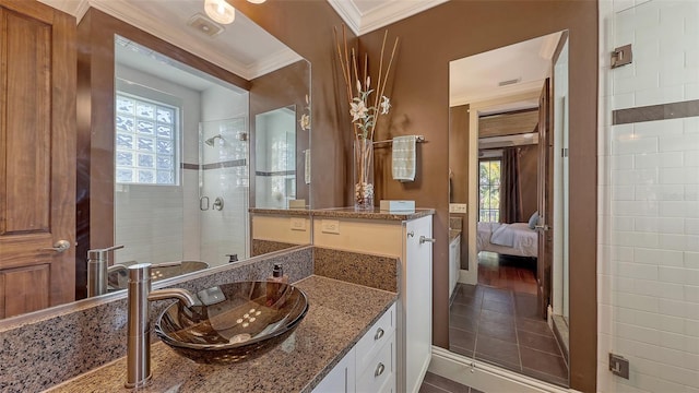 ensuite bathroom featuring ensuite bathroom, vanity, a stall shower, and crown molding