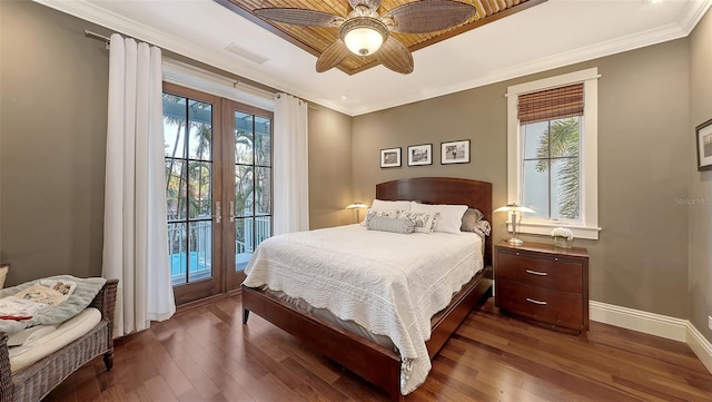 bedroom featuring access to exterior, crown molding, wood finished floors, and french doors