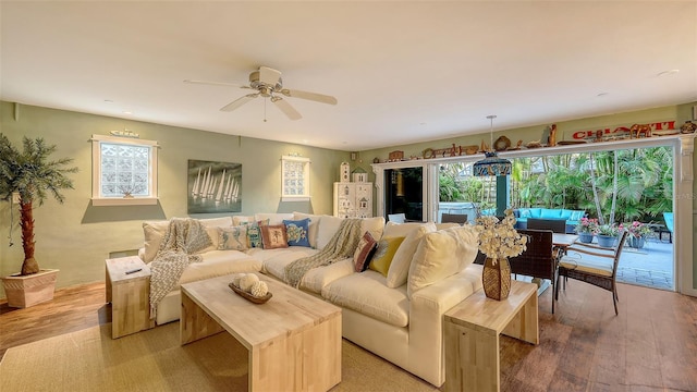 living area with ceiling fan and light wood finished floors