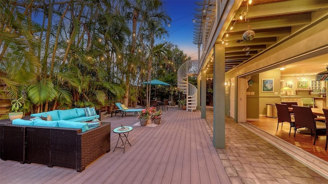 wooden terrace with outdoor lounge area, stairway, and outdoor dining area