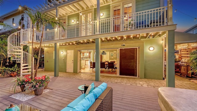 back of property featuring stairway and stucco siding