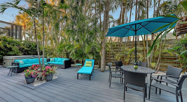 wooden terrace featuring an outdoor living space, outdoor dining area, and a hot tub