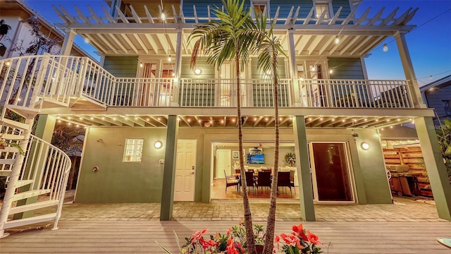 back of house featuring a balcony