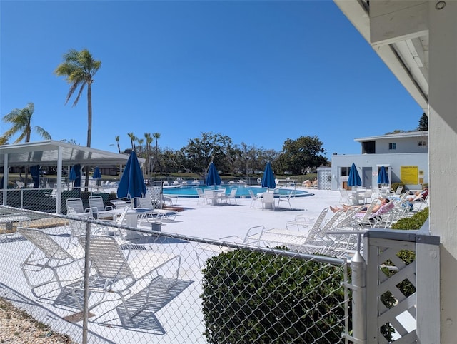 community pool featuring a patio area and fence