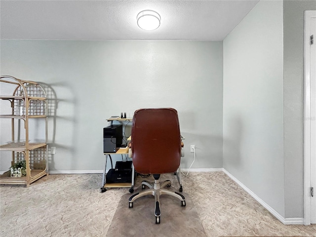 office with baseboards, a textured ceiling, and carpet floors