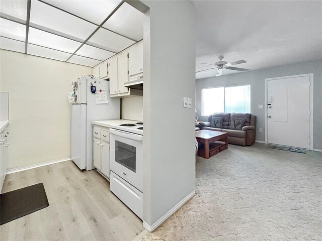 kitchen featuring white appliances, ceiling fan, light countertops, white cabinets, and under cabinet range hood