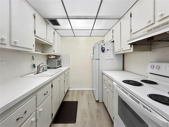 kitchen with white appliances, visible vents, a sink, light countertops, and under cabinet range hood