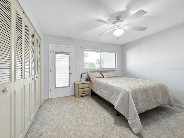 bedroom with a closet, light carpet, and ceiling fan