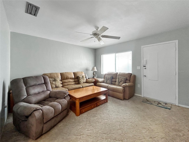 carpeted living area featuring visible vents, baseboards, and a ceiling fan