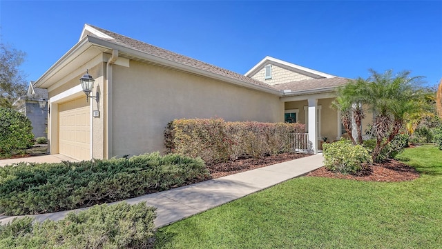 view of front of property with stucco siding, a front lawn, a garage, and a shingled roof