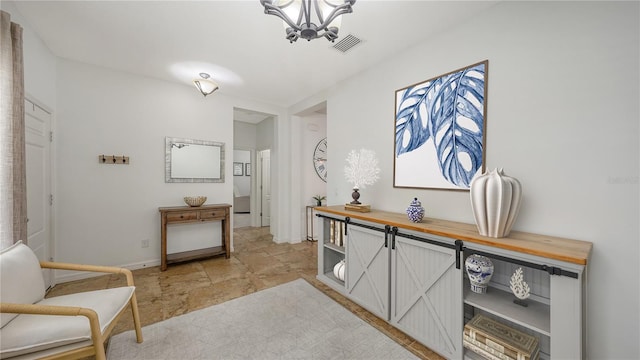 interior space featuring visible vents, baseboards, and an inviting chandelier